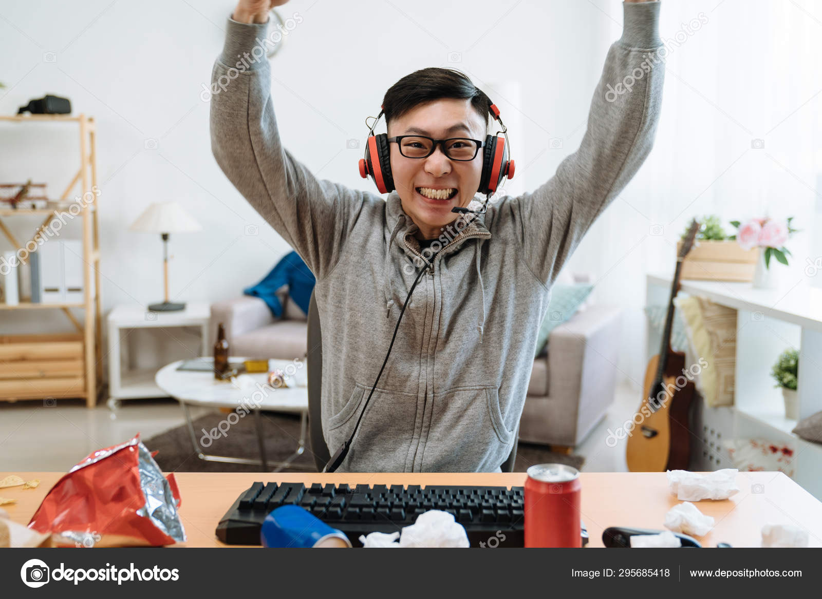 Happy Chinese Man Playing And Winning Online Game Stock Photo