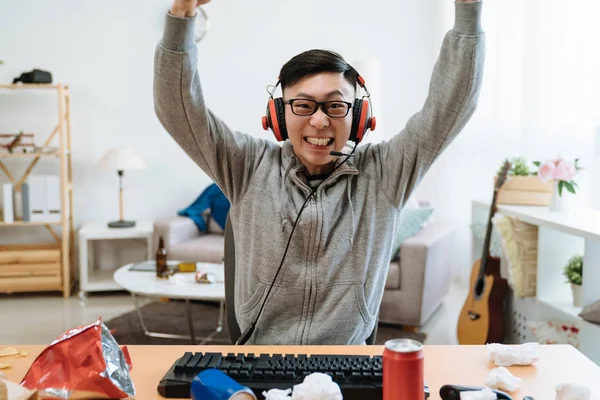 Asian Young Girl Friend Angry At Boyfriend Playing Online Game On Computer.  Mad Female Pushing Guy And Scolding At Him. Frowning Man Ignores His  Annoyed Lover And Wearing Headphones Keep Having Fun.