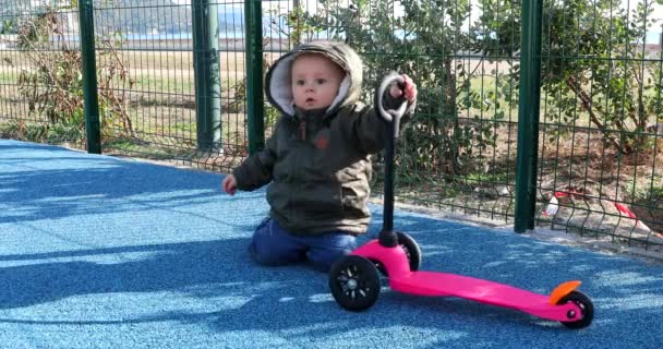Cute Baby Boy Playing Wheel Scooter Playground Close View Portrait — Stock Video