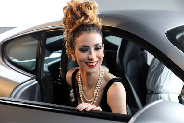 Smiling Fashion Model With A Pearl Necklace Posing In A Sports C — Stock Photo, Image