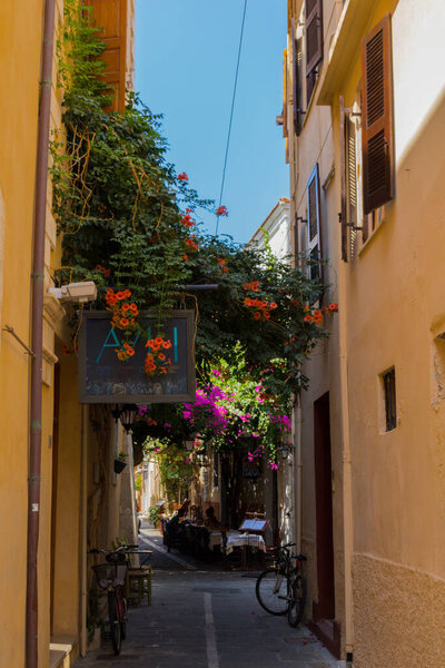 Rethymno, Greece - August 3, 2016: Narrow venetian street in old town. The old town of Rethymnon is one of the best-preserved towns of the Renaissance.
