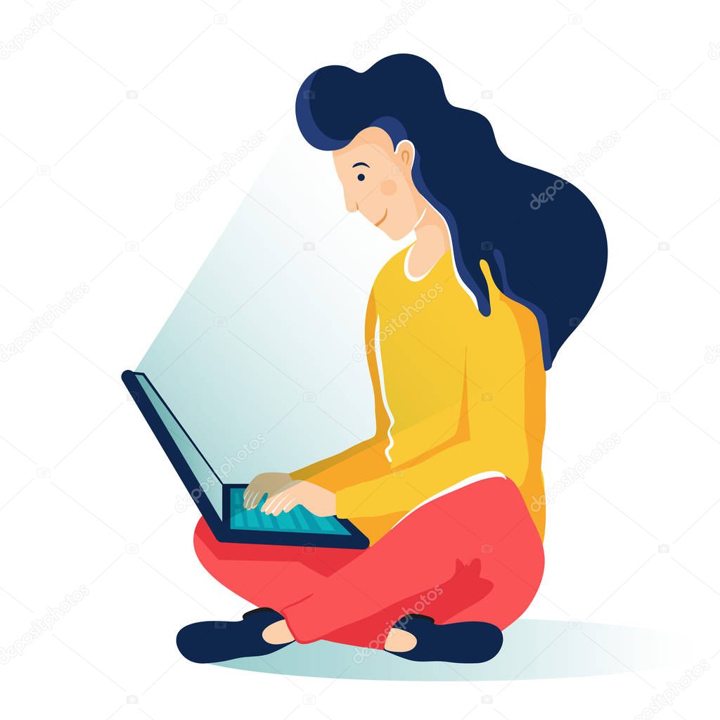 Young girl with computer sitting on the floor and working. Freelance working space. Woman typing on keyboard