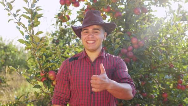 Portrait de fermier debout dans le jardin et mettre un gros doigt de mains . — Video