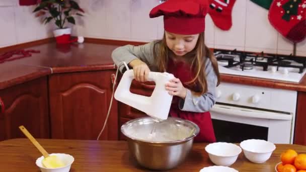 Una chica chef mezclando con la batidora eléctrica una masa en el tazón . — Vídeos de Stock