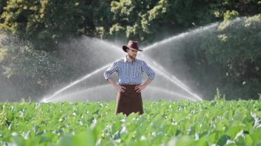 Çiftçi onun çiftliğinde su fıskiyesi çalışma sırasında ayakta