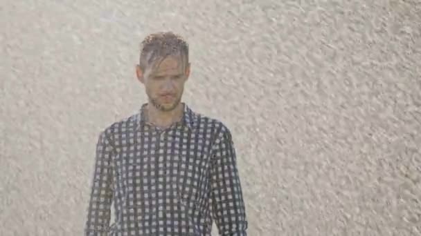 Portrait of sad man standing under the rain — Stock Video