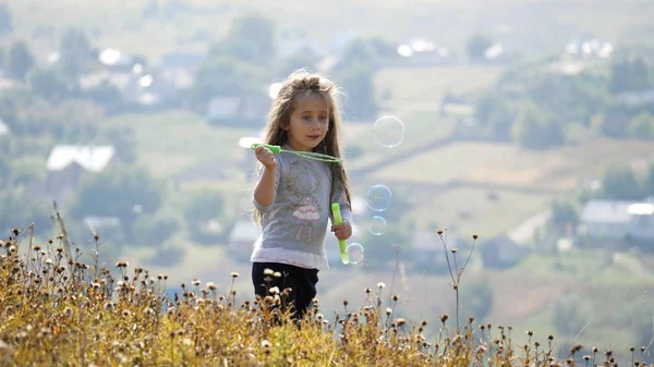 Little girls blowing soap bubbles — Stock Photo, Image