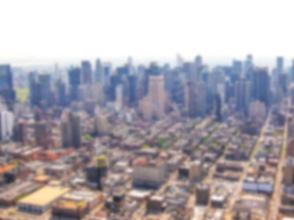 Defocused background with aerial view of skyscrapers in Manhattan, New York City, United States. Intentionally blurred post production for bokeh effect.