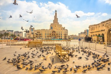 Pigeons flying at Souq Waqif clipart