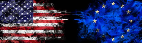 United States and Europe crisis with smoky flags — Stock Photo, Image