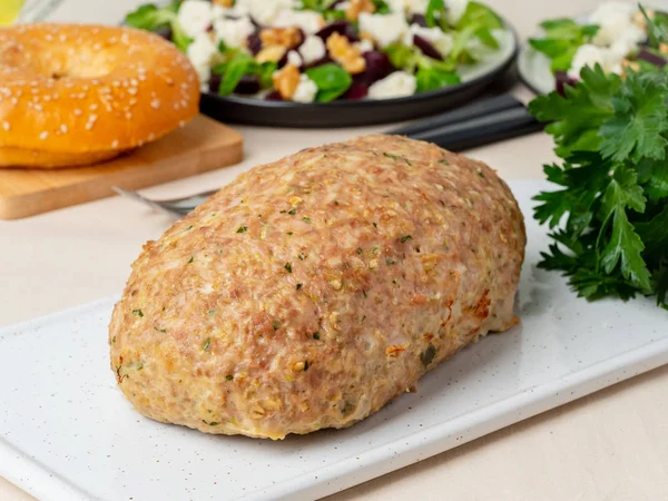 Terrine, meat loaf. Baked Turkey ground meat. Traditional French and American dish. Side view, white marble background