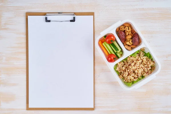 Clipboard, vegan lunch box, bottle. Healthy vegetarian menu, weight loss, healthy lifestyle