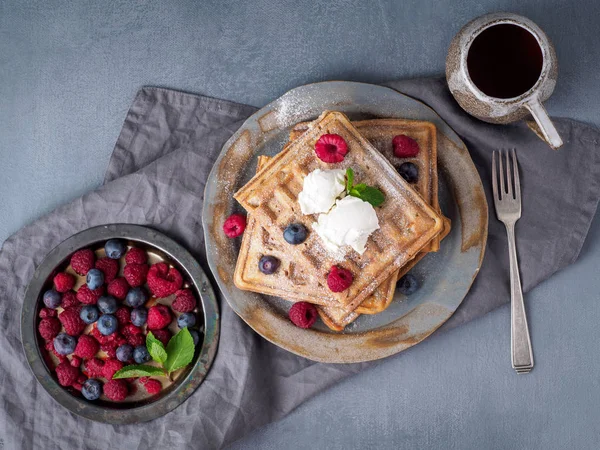 Belgian waffles with raspberries, chocolate syrup. Breakfast wit