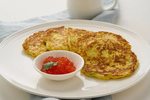 Zucchini pancakes with potato and red caviar, fodmap keto diet s