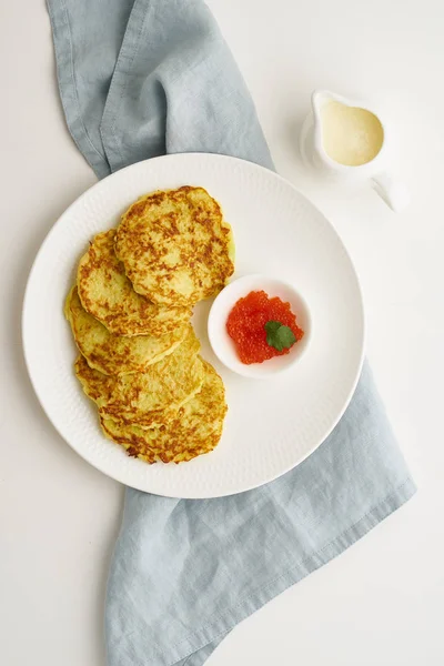 Zucchini pancakes with potato and red caviar, fodmap keto diet t