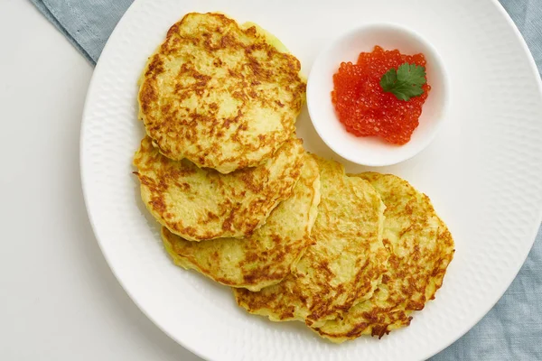 Zucchini pancakes with potato and red caviar, fodmap keto diet t