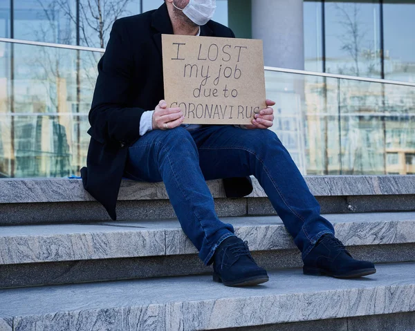 Job loss due to COVID-19 virus pandemic concept. Unrecognizable man holds sign I lost my job