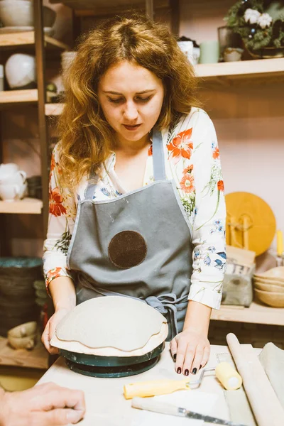 Woman making ceramic pottery on workshop. Concept for woman in freelance, business. Handcraft