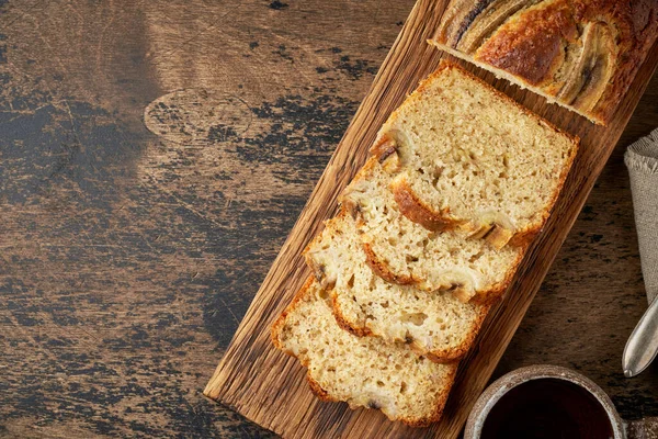 Banana bread. Cake with banana, traditional american cuisine. Slices of loaf. Dark background