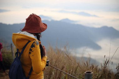 Phu Chi Fa Ulusal Parkı, Chiang Rai, Tayland 'da sisli ve dağ manzaralı bir kadın.