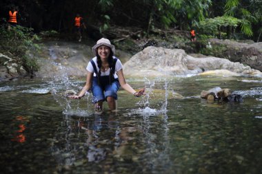 Kadınlar Khlong Phaibun Şelalesi, Chanthaburi, Tayland 'da eğleniyorlar.