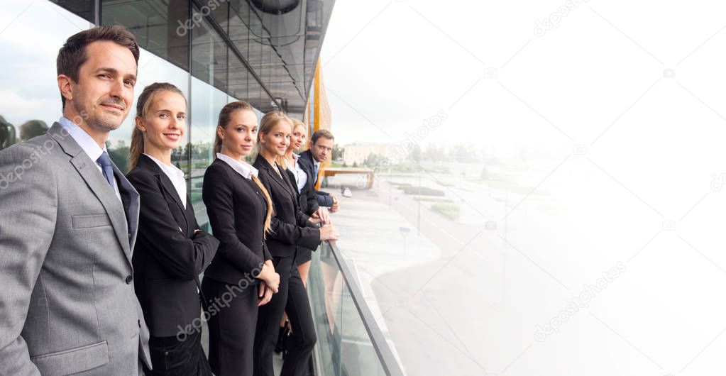 Business people team standing in a row at the balcony of modern office building