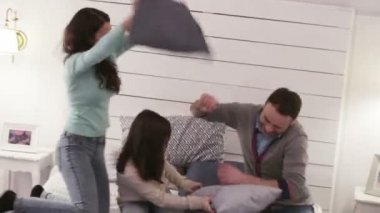 İnsanlar, aile kavramı - yastık sahip ailesiyle mutlu çocuk evde yatakta kavga