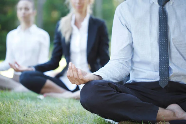 Business people practicing yoga — Stock Photo, Image