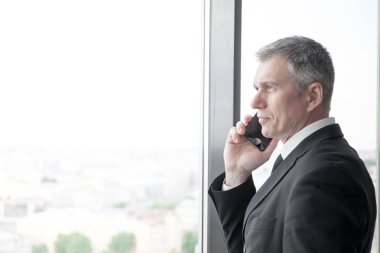 İş adamı telefonda konuşuyor.