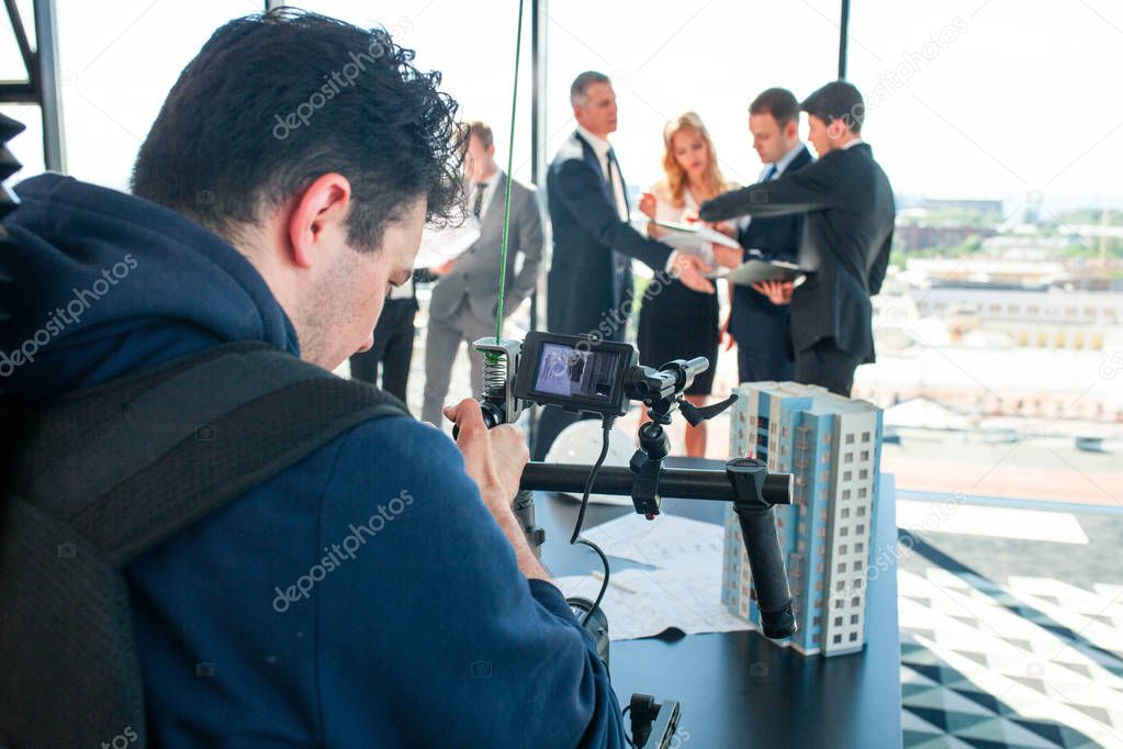 Videographer filming business meeting