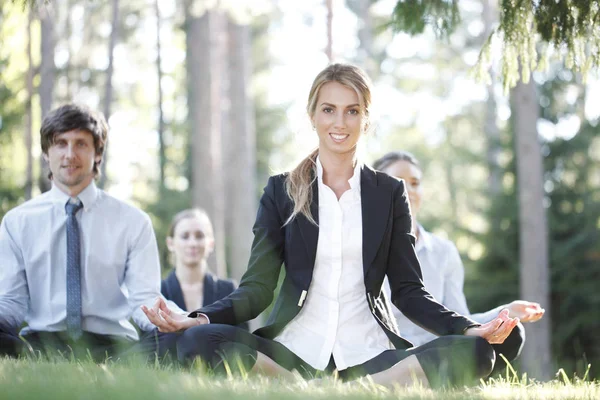 Business people practicing yoga — Stock Photo, Image