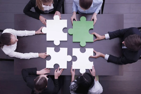 Business people assembling puzzle — Stock Photo, Image