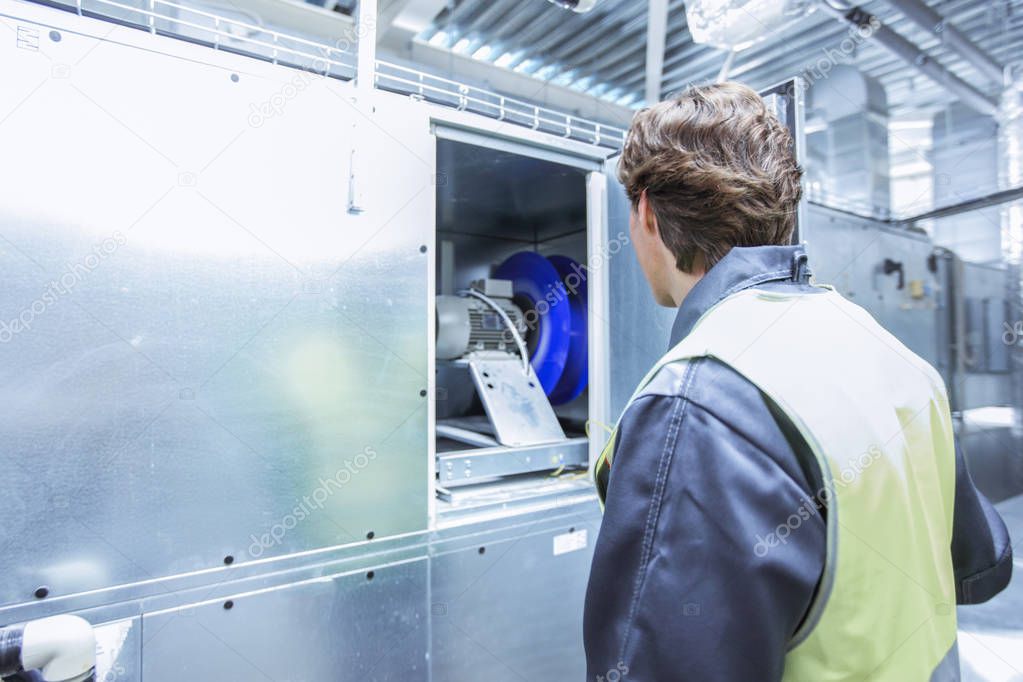 Worker in electrical switchgear room