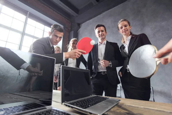 Business people play ping pong