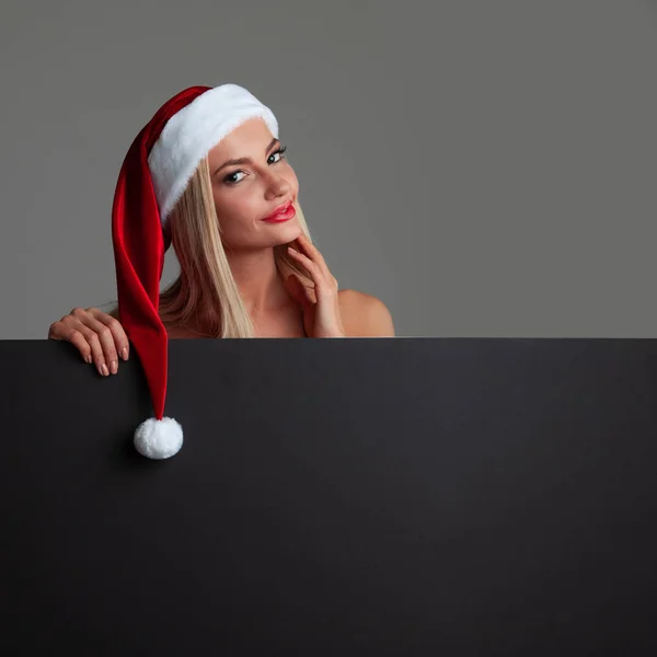 Santa girl holding blank billboard — Stock Photo, Image
