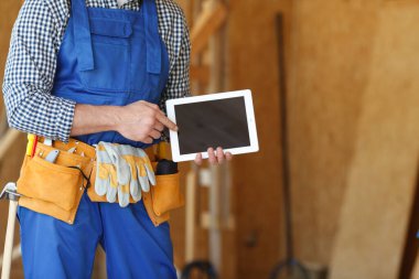 İnşaat işçisi boş dijital tablet bilgisayarına işaret ediyor metin için kopyalama alanı ile