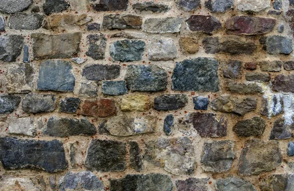 Textur der alten Steinmauer. Deutlich sichtbares Kopfsteinpflaster. — Stockfoto