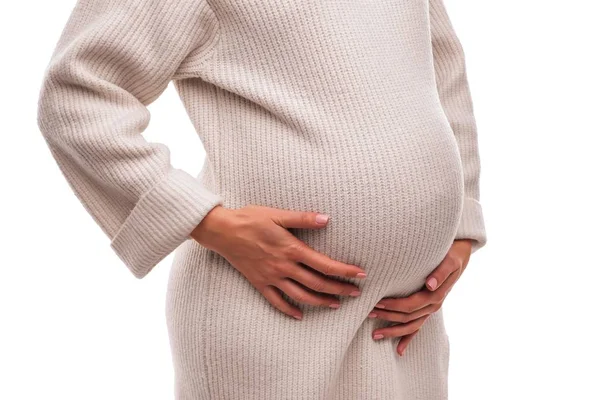 Figur einer schwangeren Frau im warmen Winterpullover. — Stockfoto