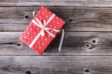Ahşap arka planda kırmızı hediye kutusu.