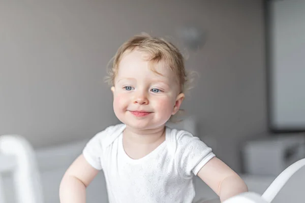 Cheerful little girl child plays in a good mood. — Stock Photo, Image