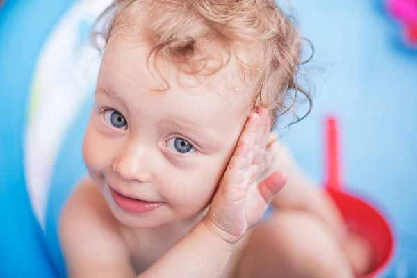 Child girl bathes in a bathtub or pool with toys. — Stock Photo, Image