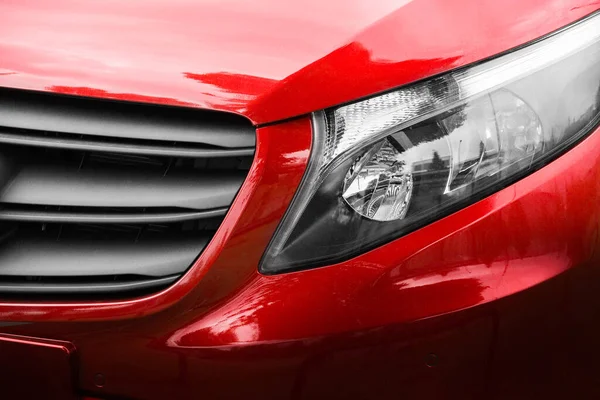 Red car. Front view of a new car. Modern car close up. Car background.