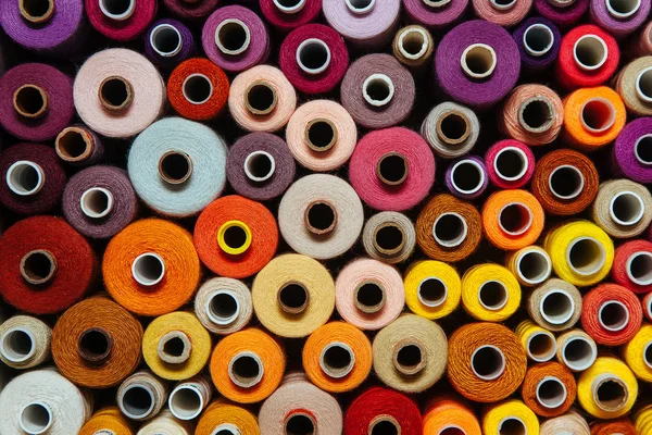 Farklı renklerde iplikler. Dikiş ve dikiş işleri için birçok iplik renk ve boyut olarak farklıdır. Tartışmaların rengarenk paleti.