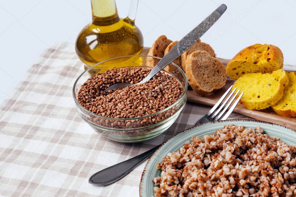 Buckwheat porridge plate bread table yellow brown cereal groats graine cooked boiled oil food