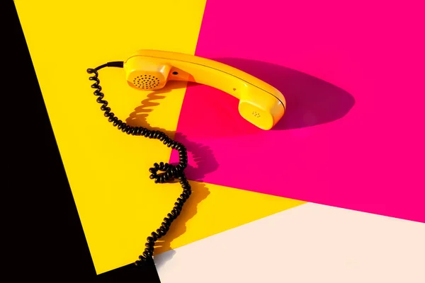 Retro vintage phone handset yellow pink red purple plastic orange disko background old style shadow 90 black