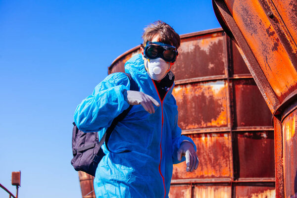 man environmental mask face pack disguise facemask bitmask protective overall blue orange rast plant factory disused catastrophe