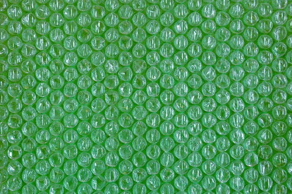 Plástico fundo textura celofane embalagem embalagem envoltório pacote talão bola verde verdes ufo trópico brilhante — Fotografia de Stock