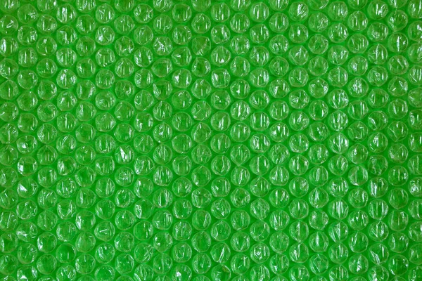 Plástico fundo textura celofane embalagem embalagem envoltório pacote talão bola verde verdes ufo trópico brilhante — Fotografia de Stock