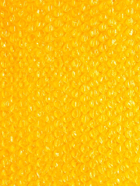 Fundo de plástico textura celofane embalagem embalagem envoltório pacote talão bola brilhante laranja amarelo quente sol — Fotografia de Stock