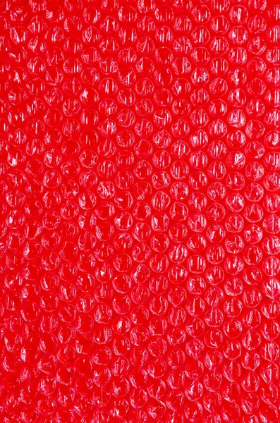 Fundo de plástico textura celofane embalagem embalagem envoltório pacote bola vermelho baga sangue sangrento cor brilhante — Fotografia de Stock